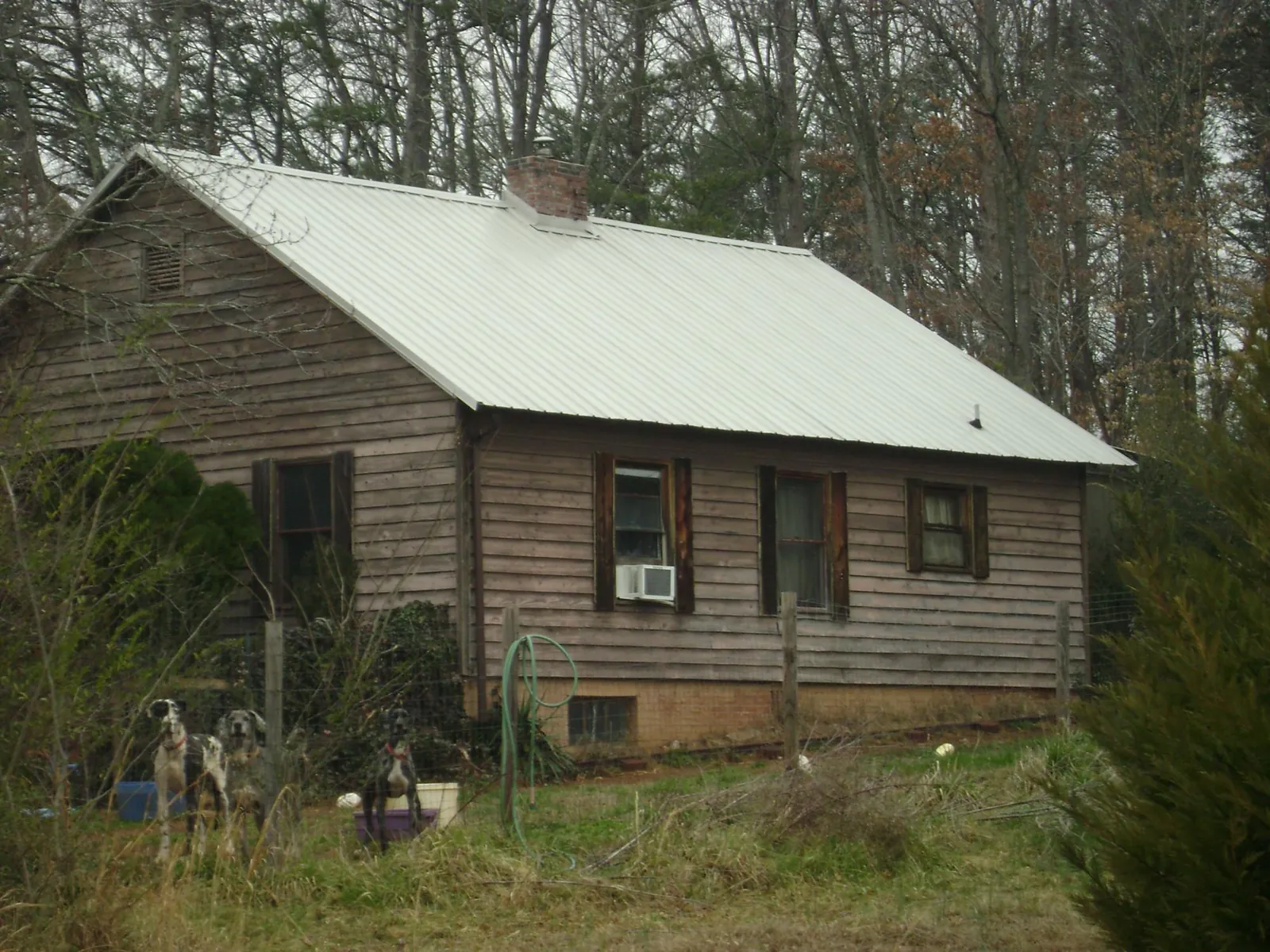 White metal roof on an old wood sided farmhouse, from a Metal Roof Installation job in Hankinson